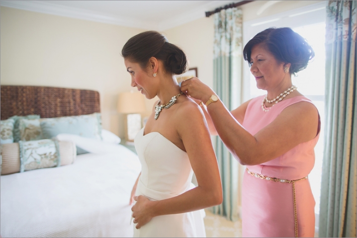 mother of the bride putting on necklace
